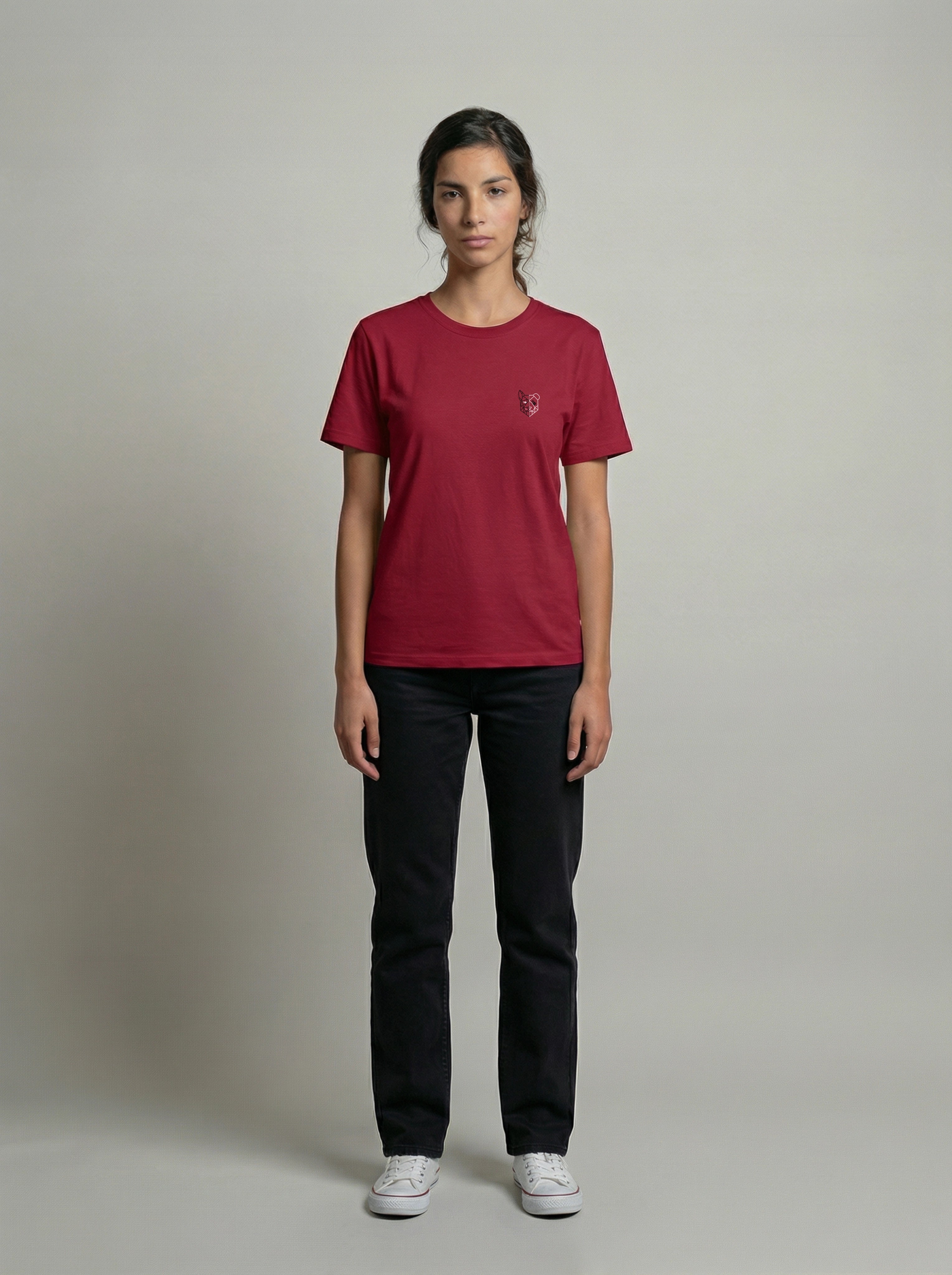 Person wearing a burgundy t-shirt and black pants on a plain background