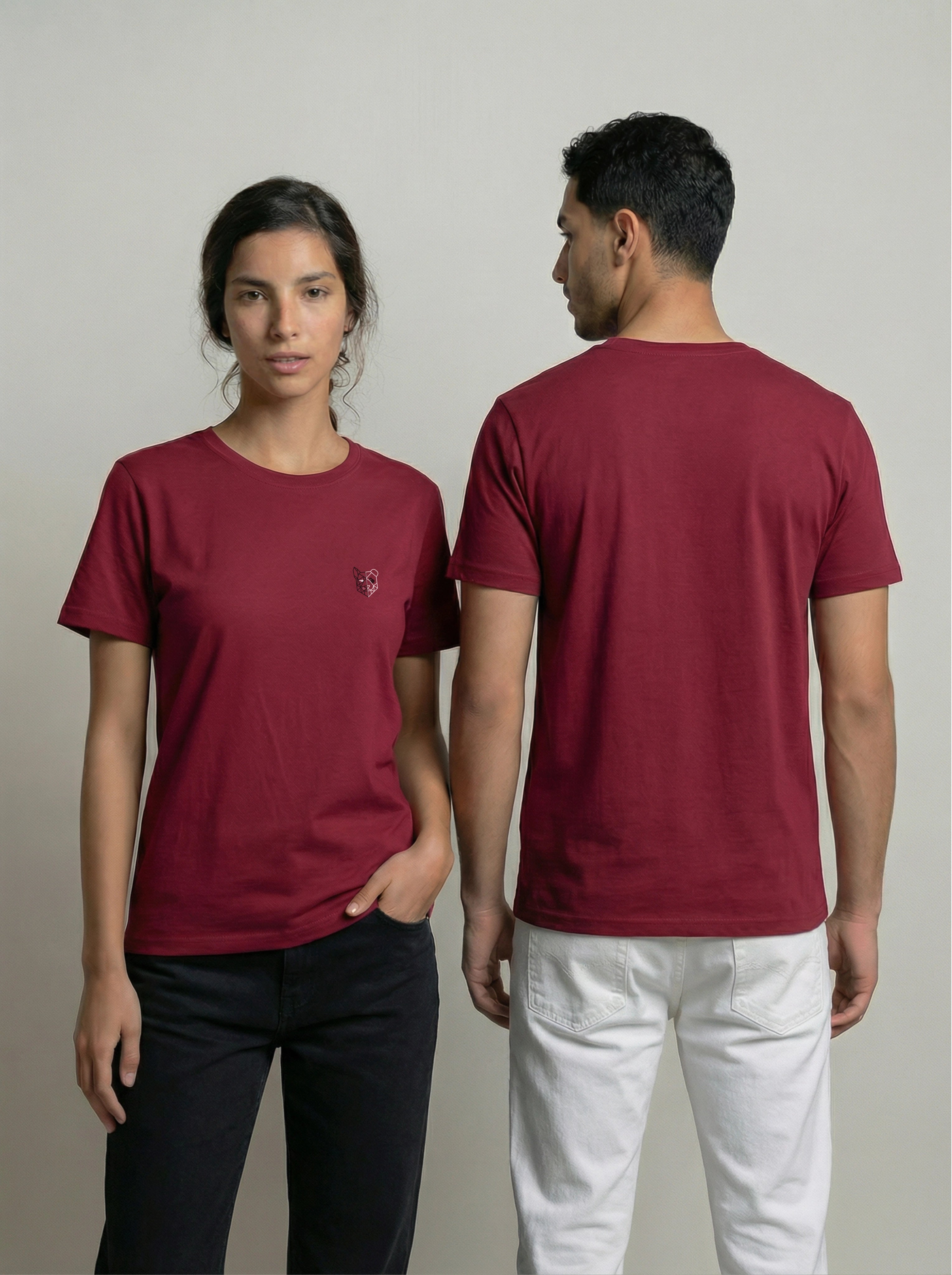 Two people wearing burgundy t-shirts, one facing forward and the other facing backward, on a plain background.