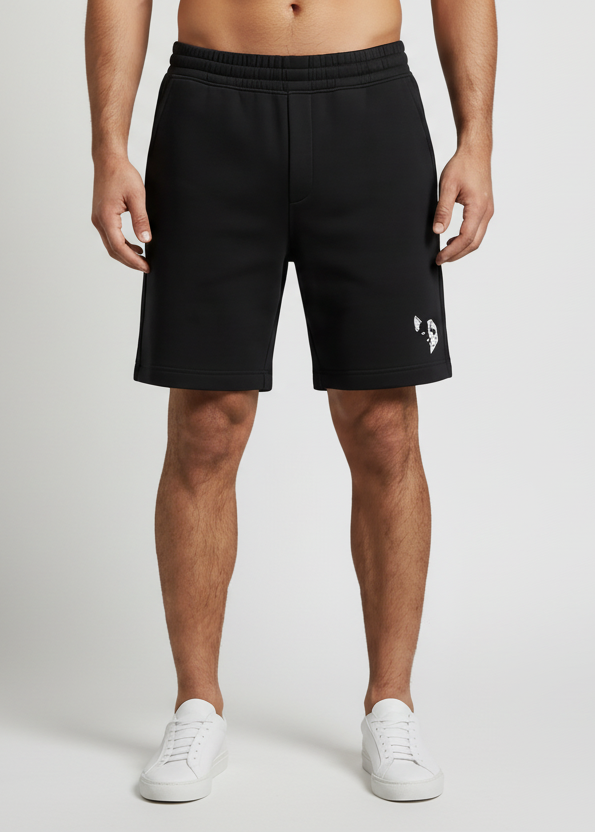 Person wearing black shorts with a small padoganda graphic logo on a white background