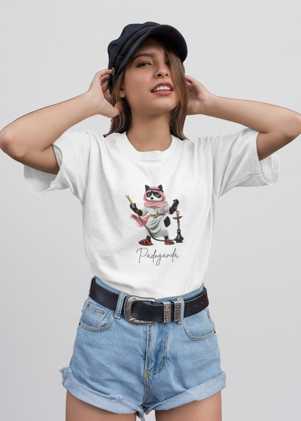 Person wearing a white t-shirt with a smokey shisha cartoon character and text, paired with denim shorts and a cap.